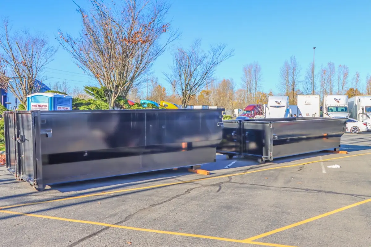 Professional dumpster rental service with roll-off container on residential driveway in New Kensington